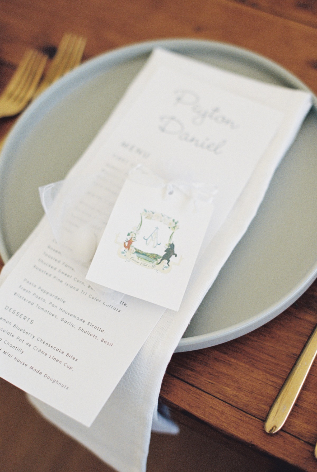 Watercolor wedding crest on elegant wedding dinner menu