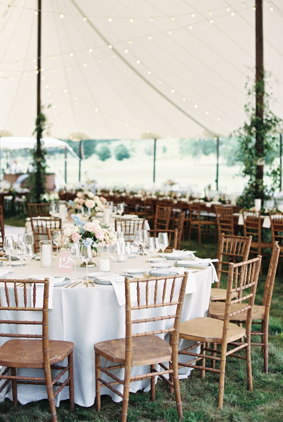Rustic pastel garden party reception under white tent 