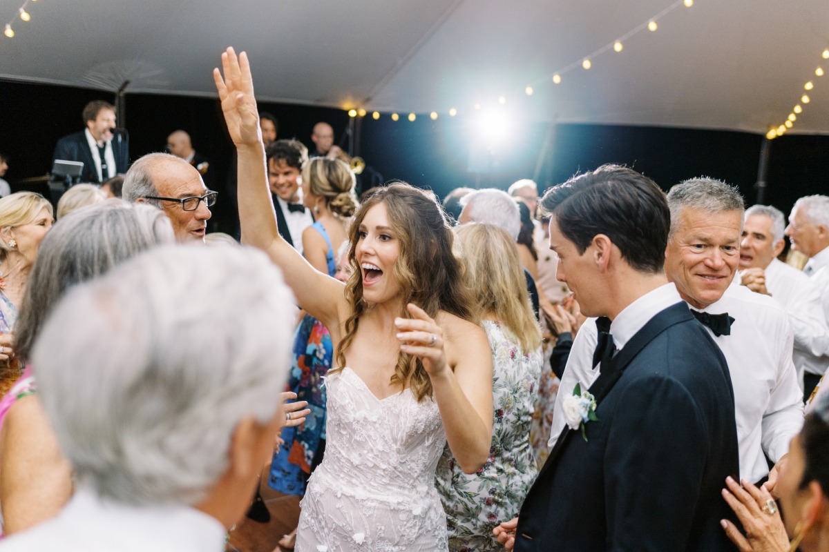Bride dancing to live band on reception dance floor 