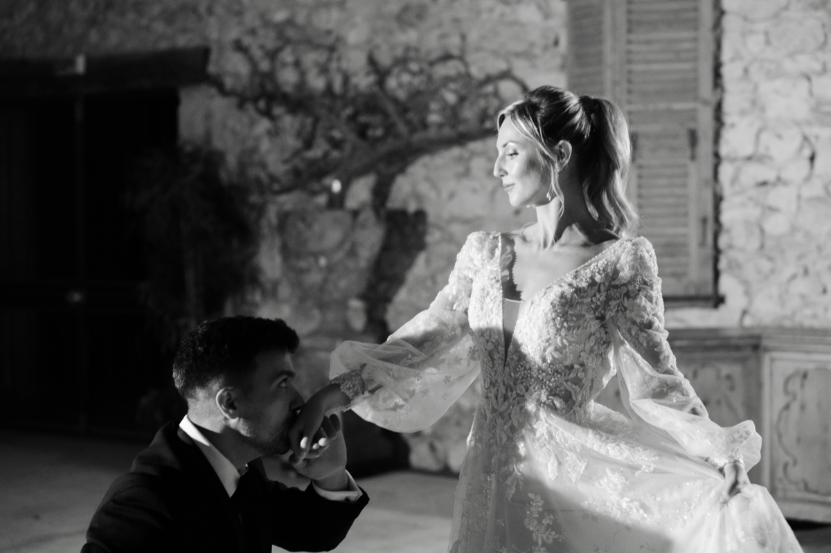 Romantic kiss on the hand after first dance at French chateau