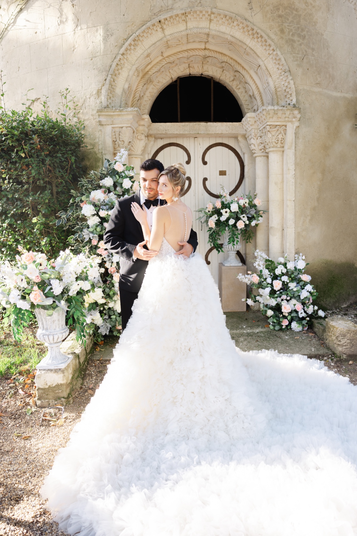 Dreamy French wedding couple at silk floral ceremony 