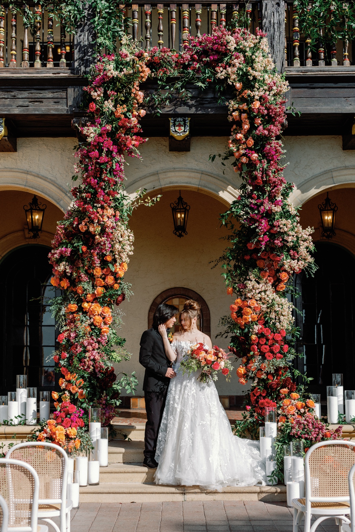 Towering modern sunset palette floral wedding arch 