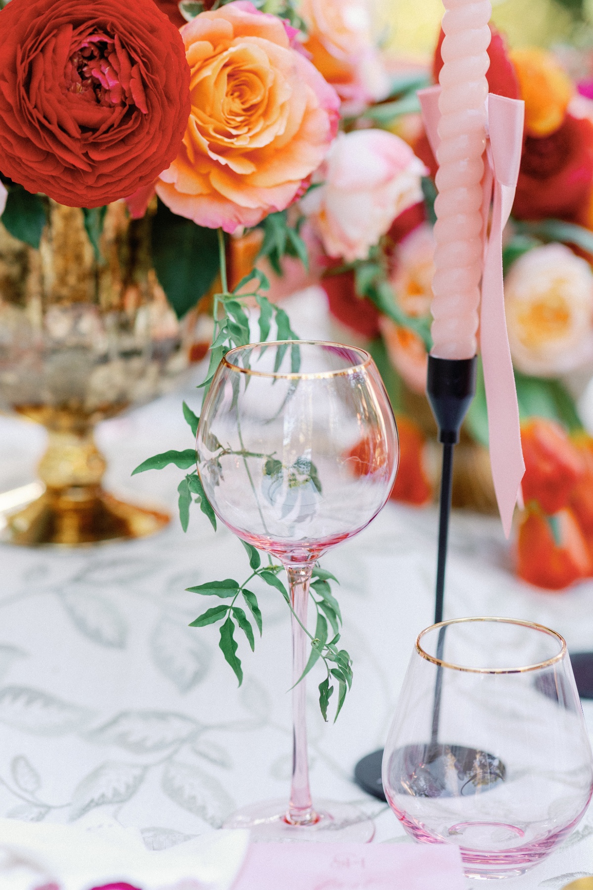 Pink and gold glassware for pastel floral reception