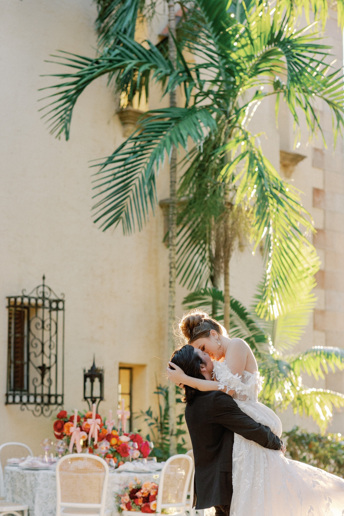 Romantic bride and groom kiss at tropical Florida estate wedding