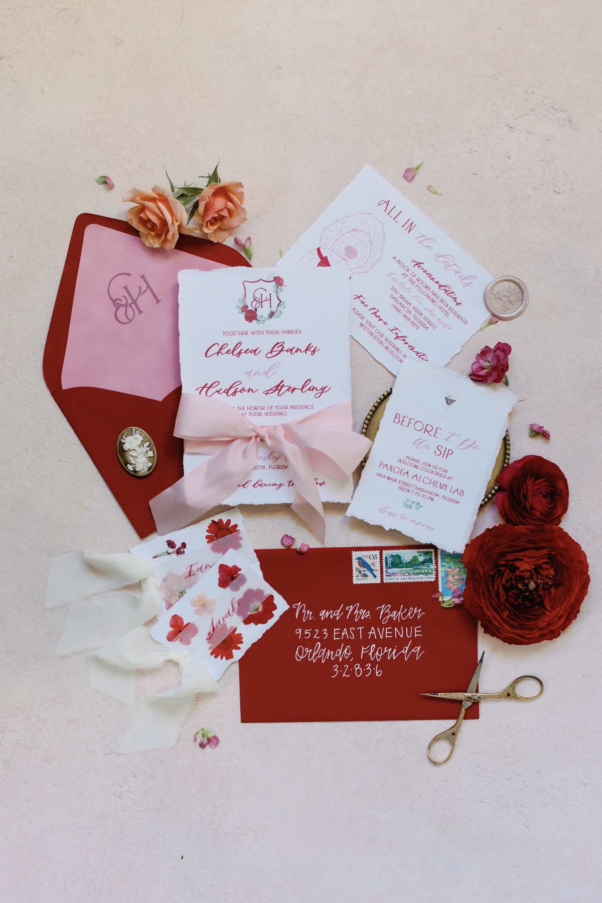 Vibrant red and white wedding invitations with pink ribbon