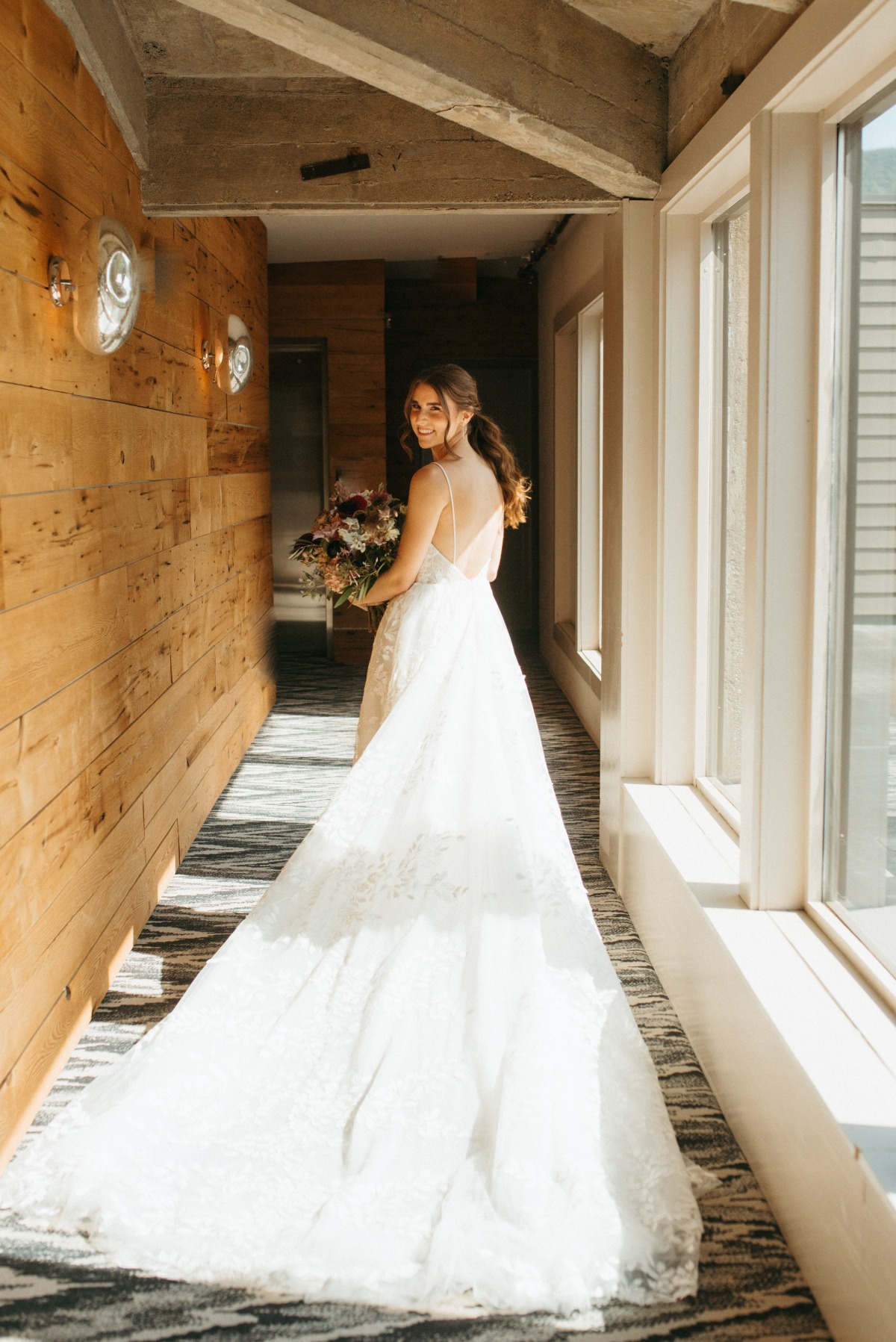 Bride posing in floral tulle wedding dress by Vagabond Bridal