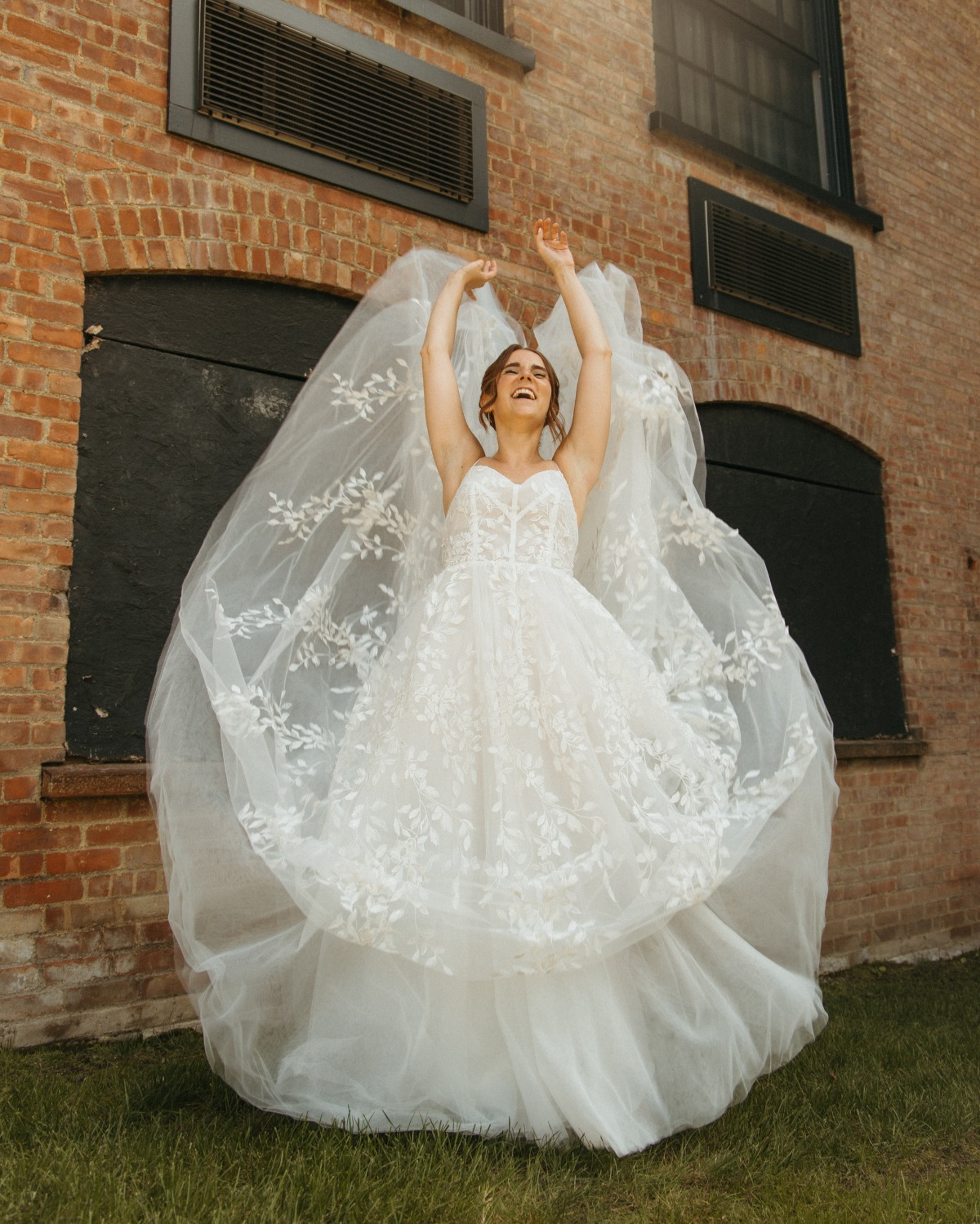 Bride playing with floral tulle wedding dress by Vagabond Bridal
