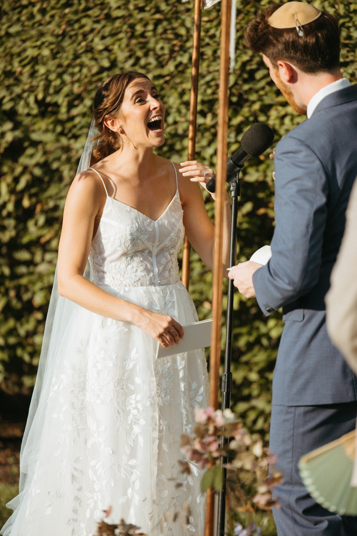 Modern bride laughing at vows at Hudson Valley wedding 
