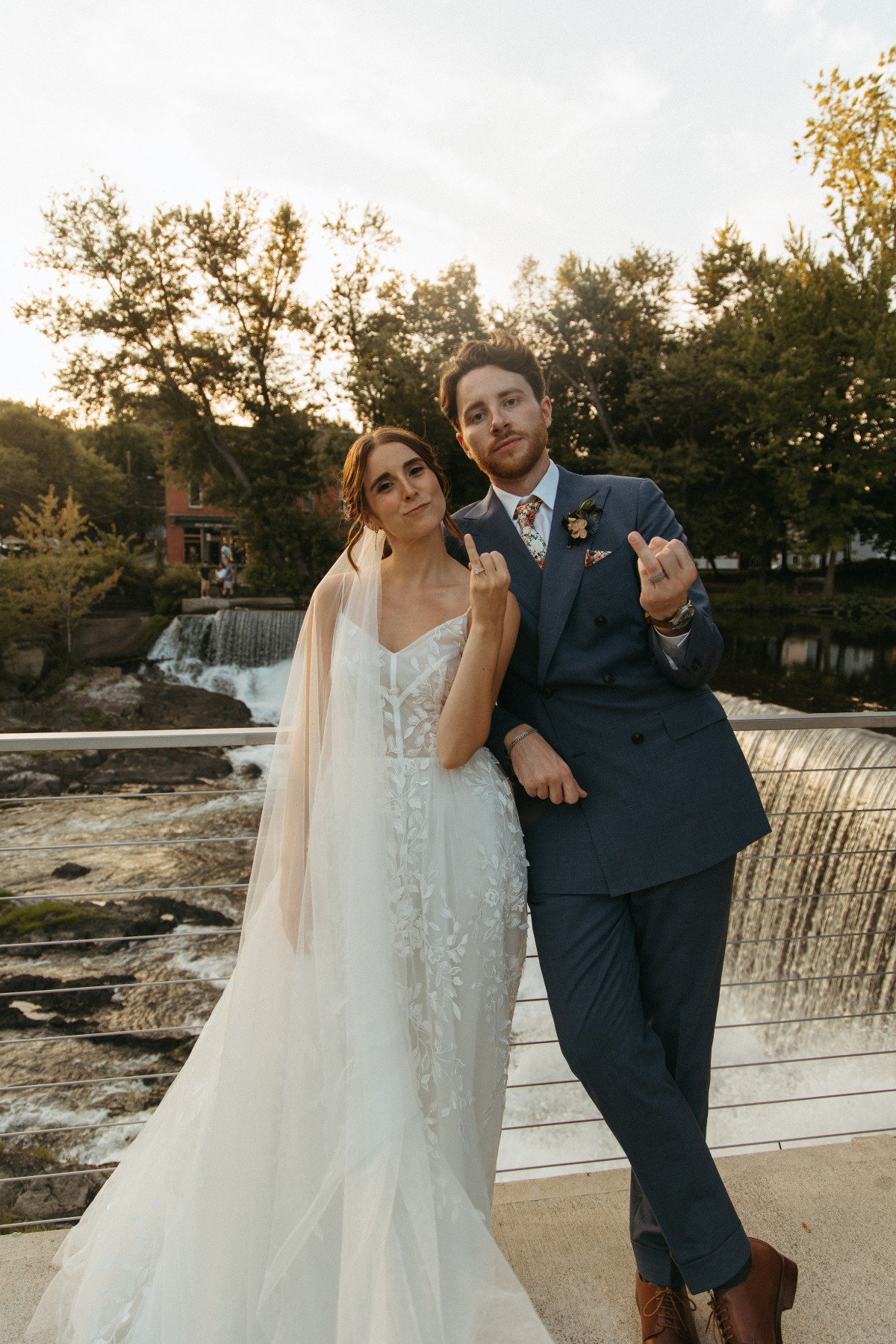 Playful bride and groom sunset photos with waterfall