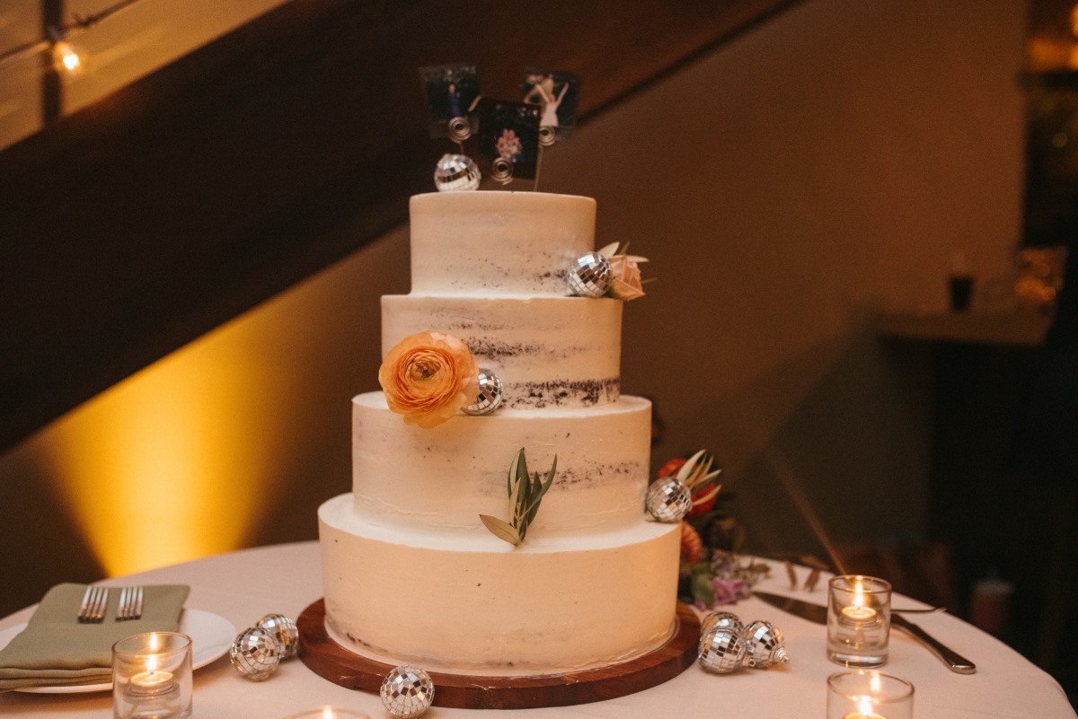 Modern wedding cake with disco balls and floral details