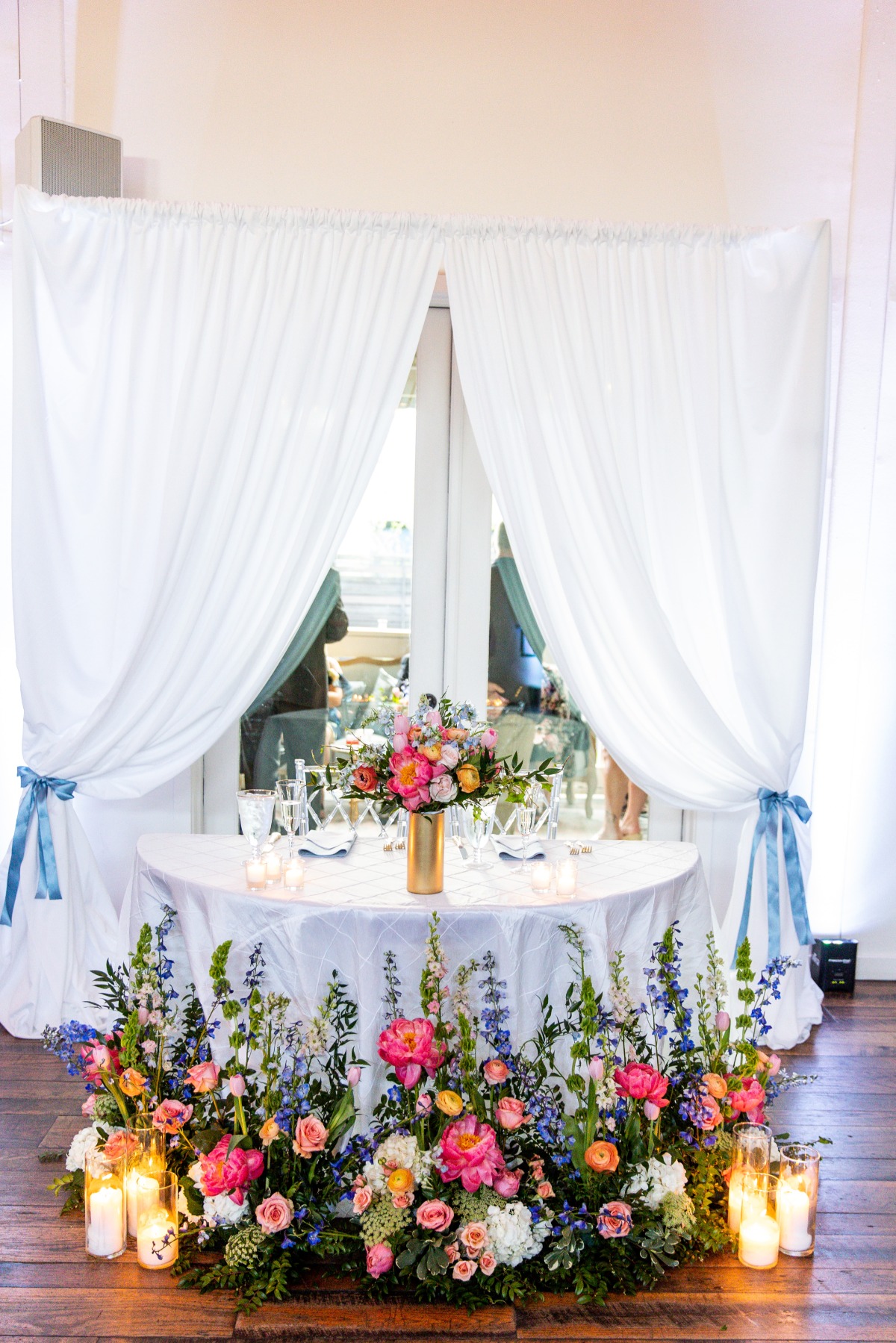 sweetheart table surrounded by summer flowers