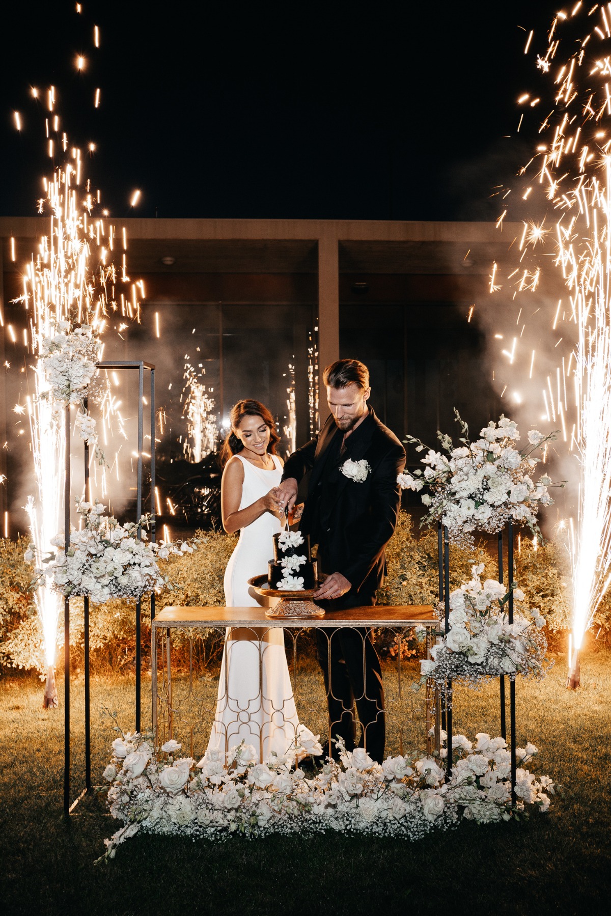 wedding cake cutting with cold sparklers