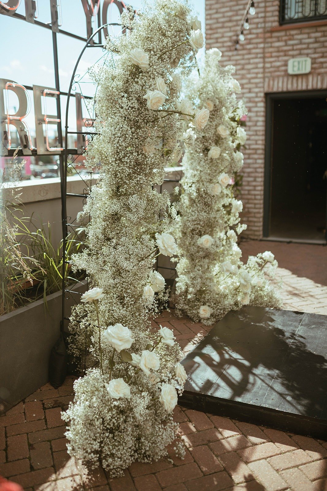 baby's breath and white rose arch