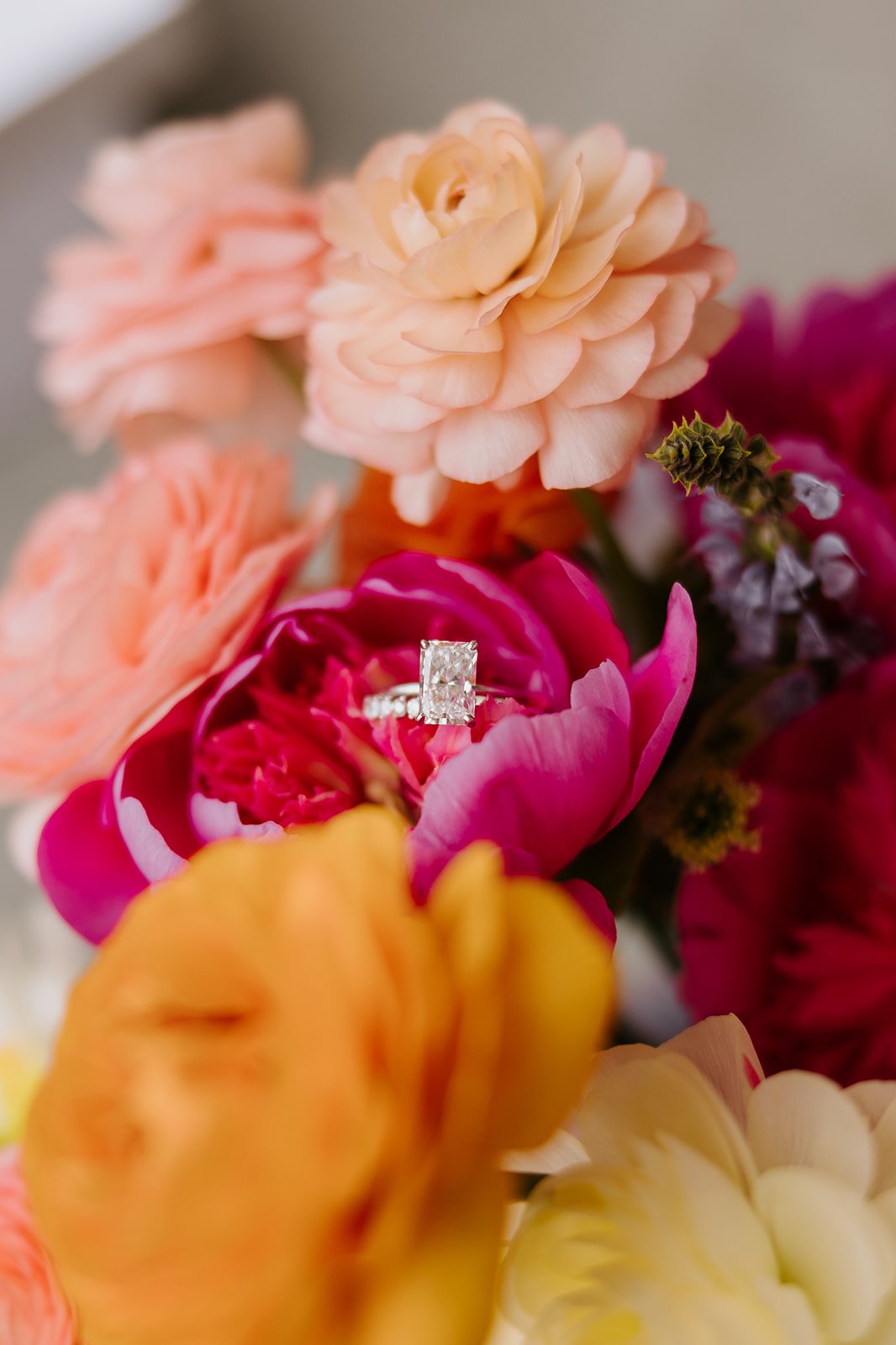 Modern rectangular cut engagement ring in colorful bouquet 