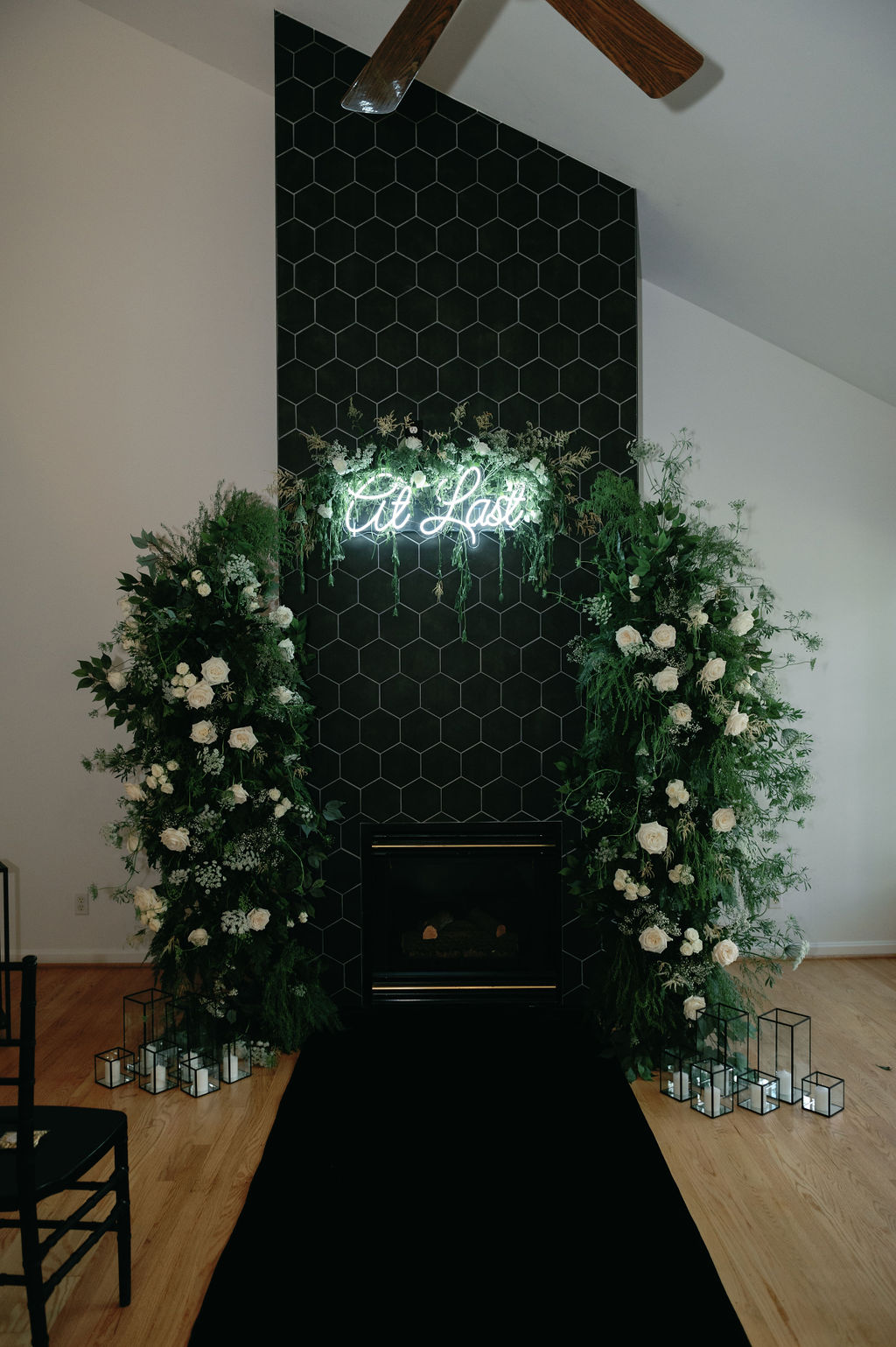 white rose and greenery ceremony arch