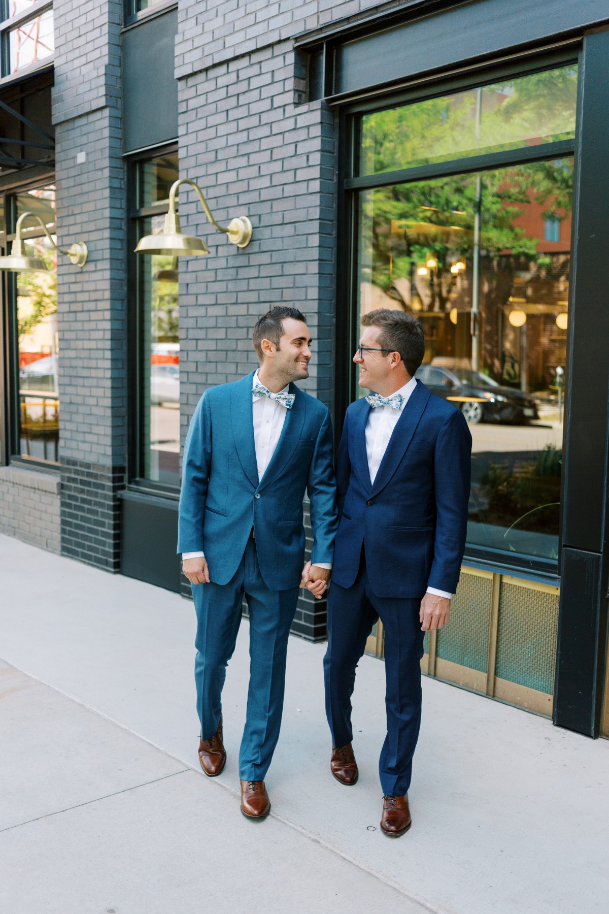 Stylish Denver grooms in custom blue suits with bow ties 