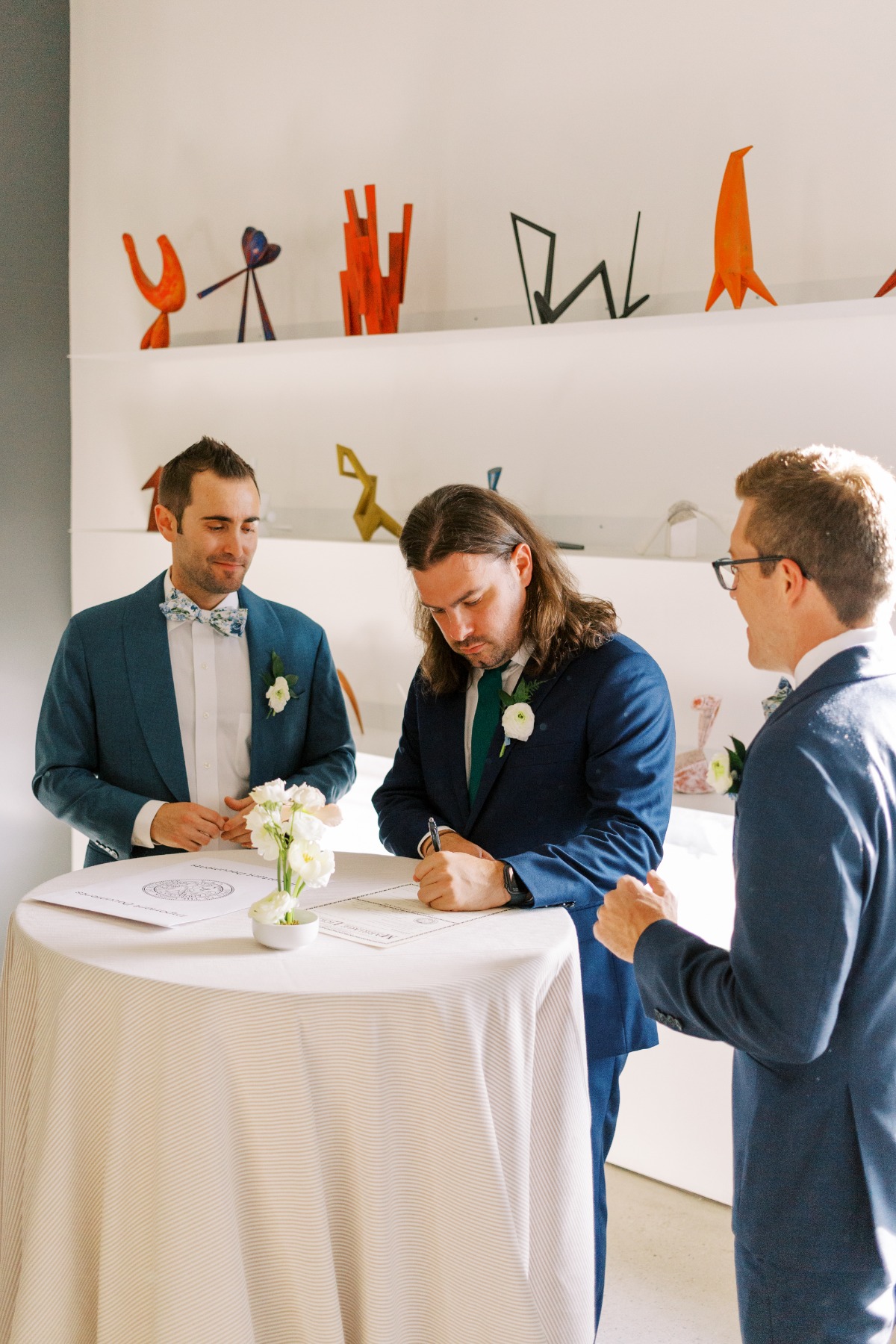 Two grooms signing marriage license at Space Gallery 