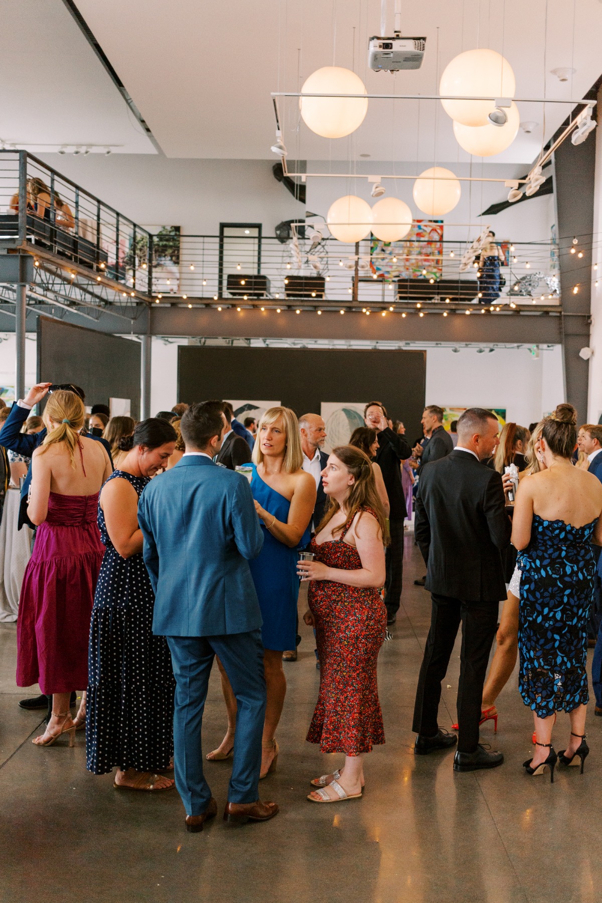 Stylish wedding guests enjoy cocktail hour before ceremony