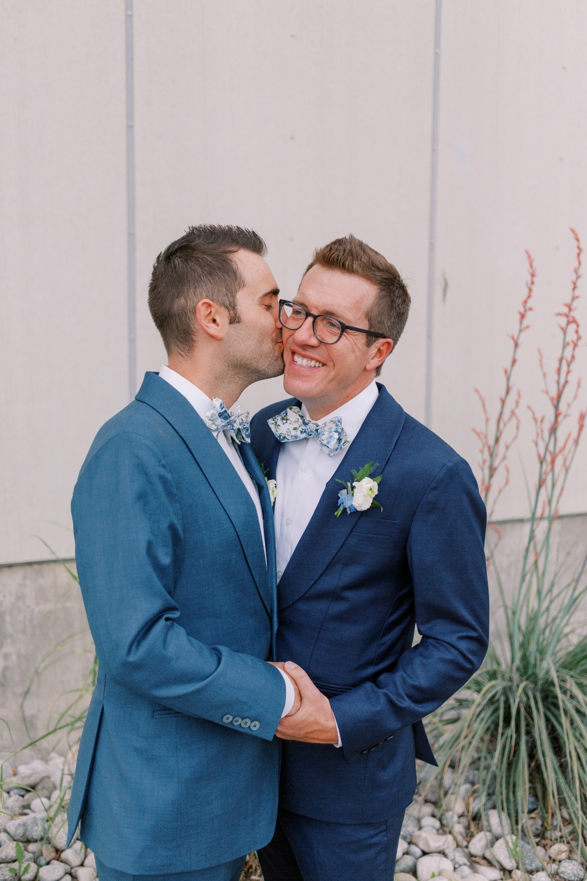 Grooms kissing cheek at Space Gallery wedding in Denver