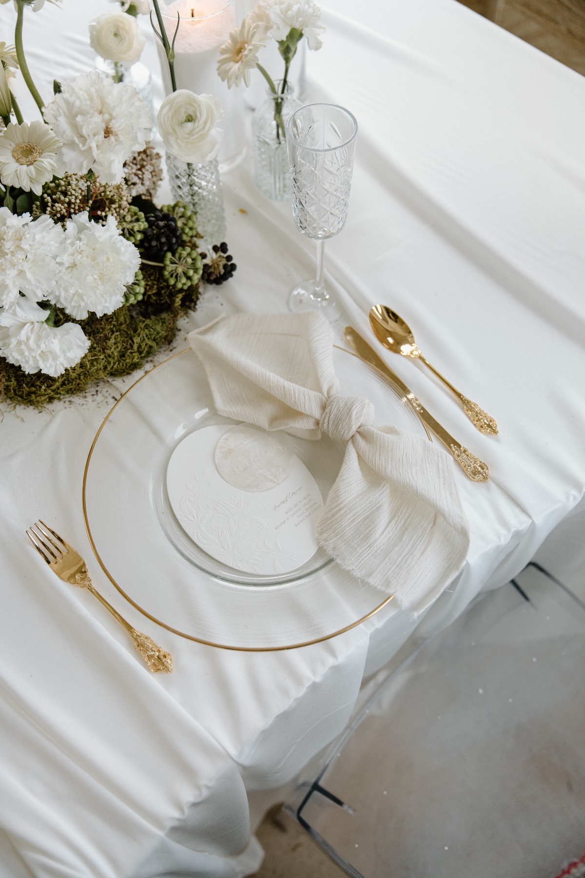 clear place settings with gold flatware