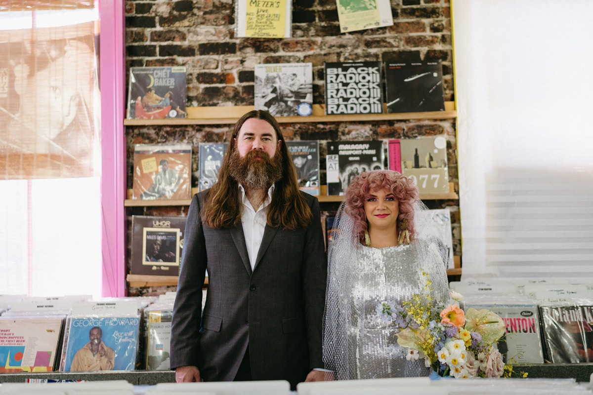 non-traditional wedding portraits in a record store