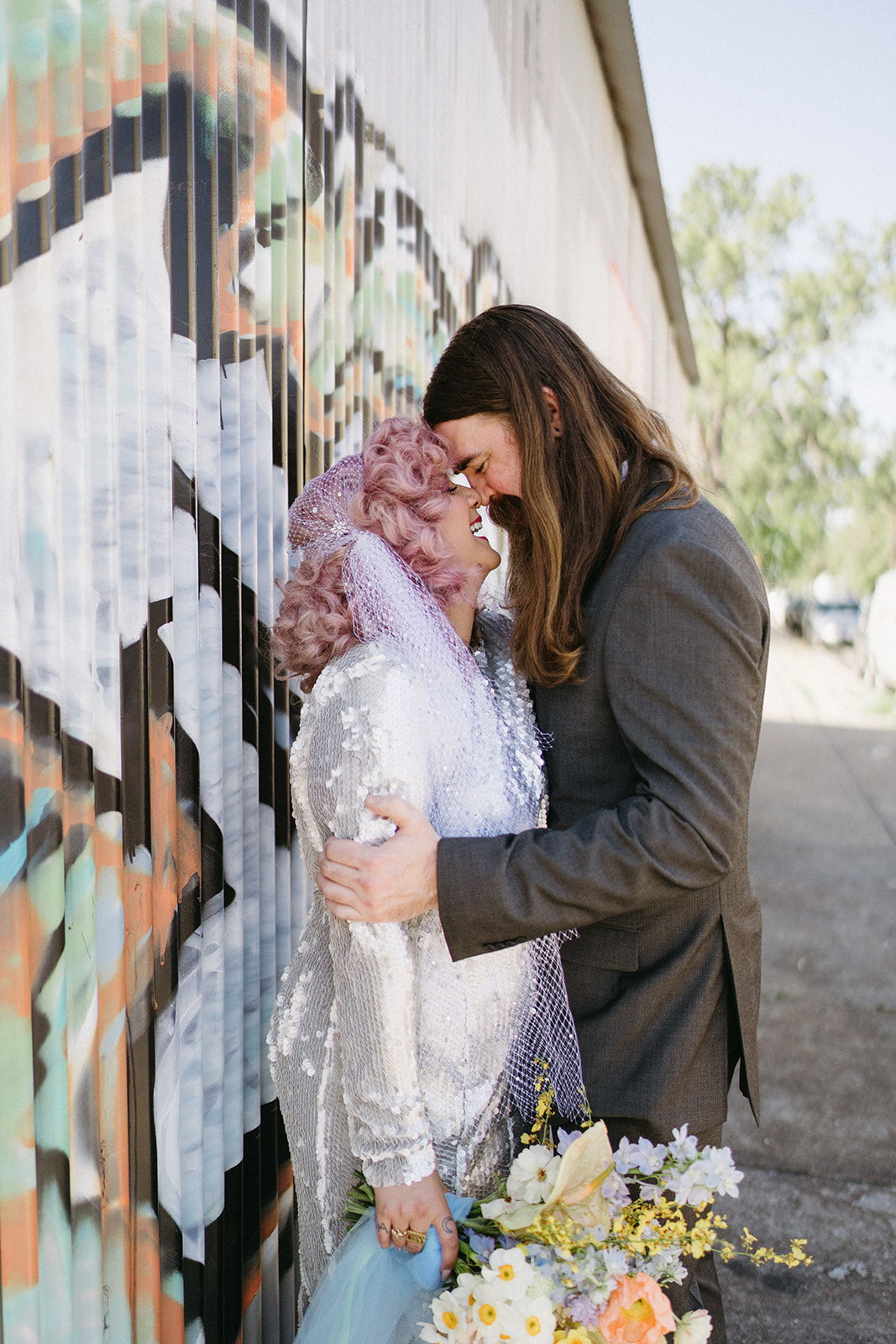 cute non-traditional bride and groom portrait by graffiti in new orleans