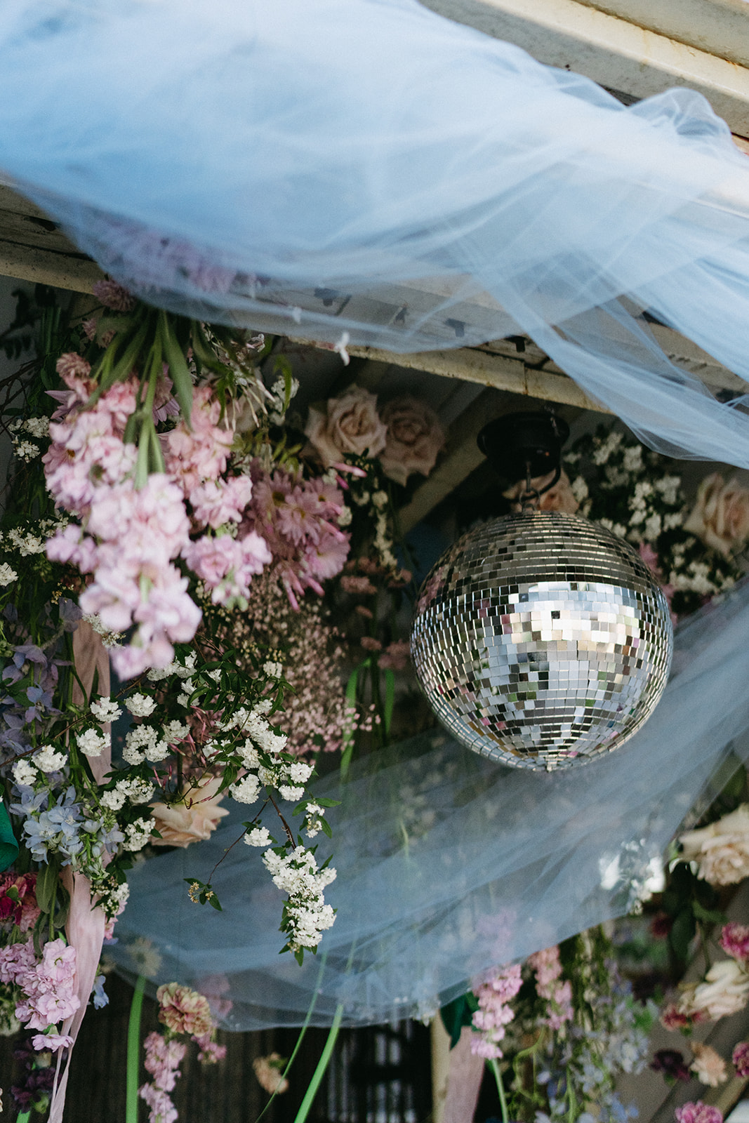 disco ball wedding alter with hanging flowers