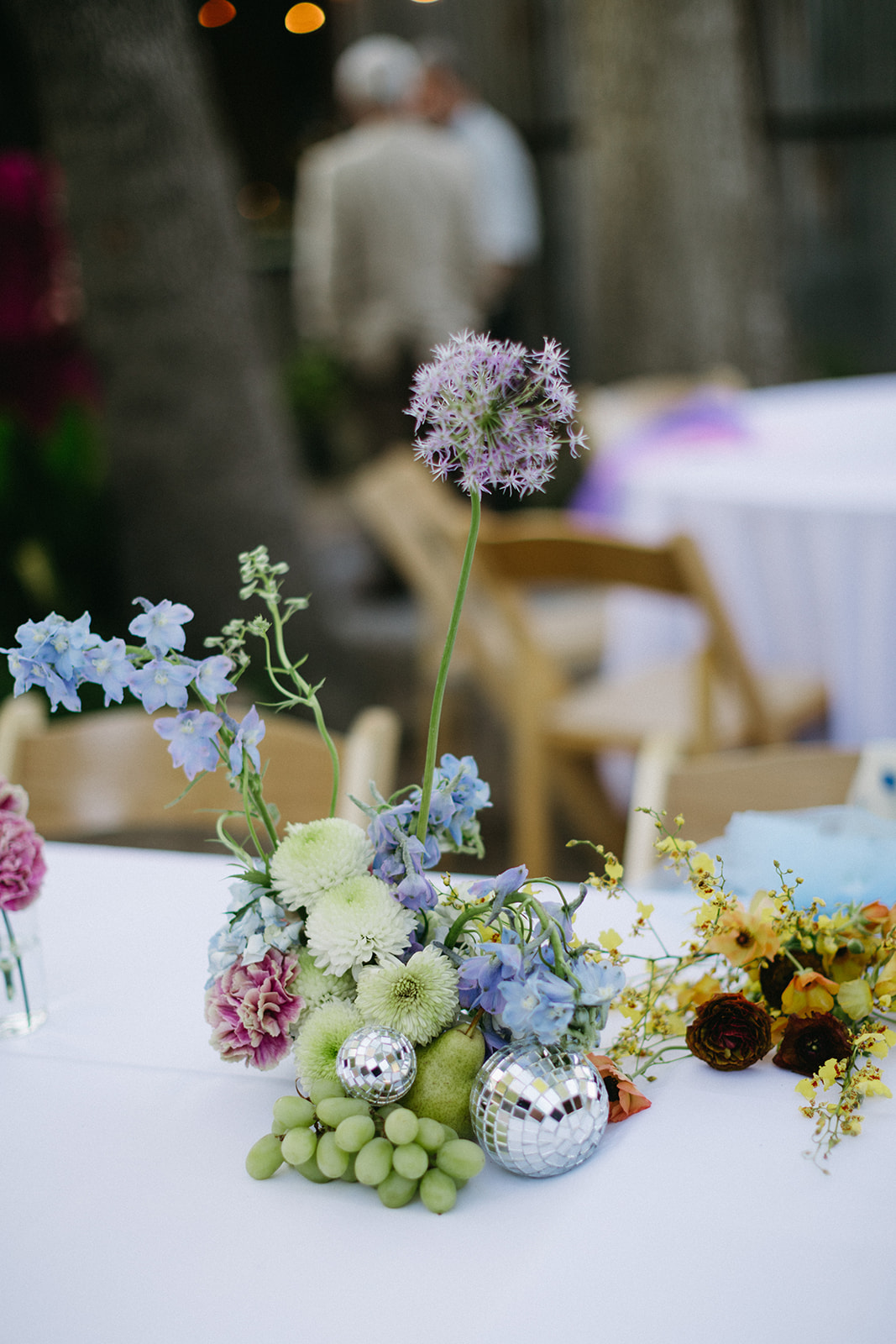 mix and match pastel wedding centerpieces with grapes and disco balls