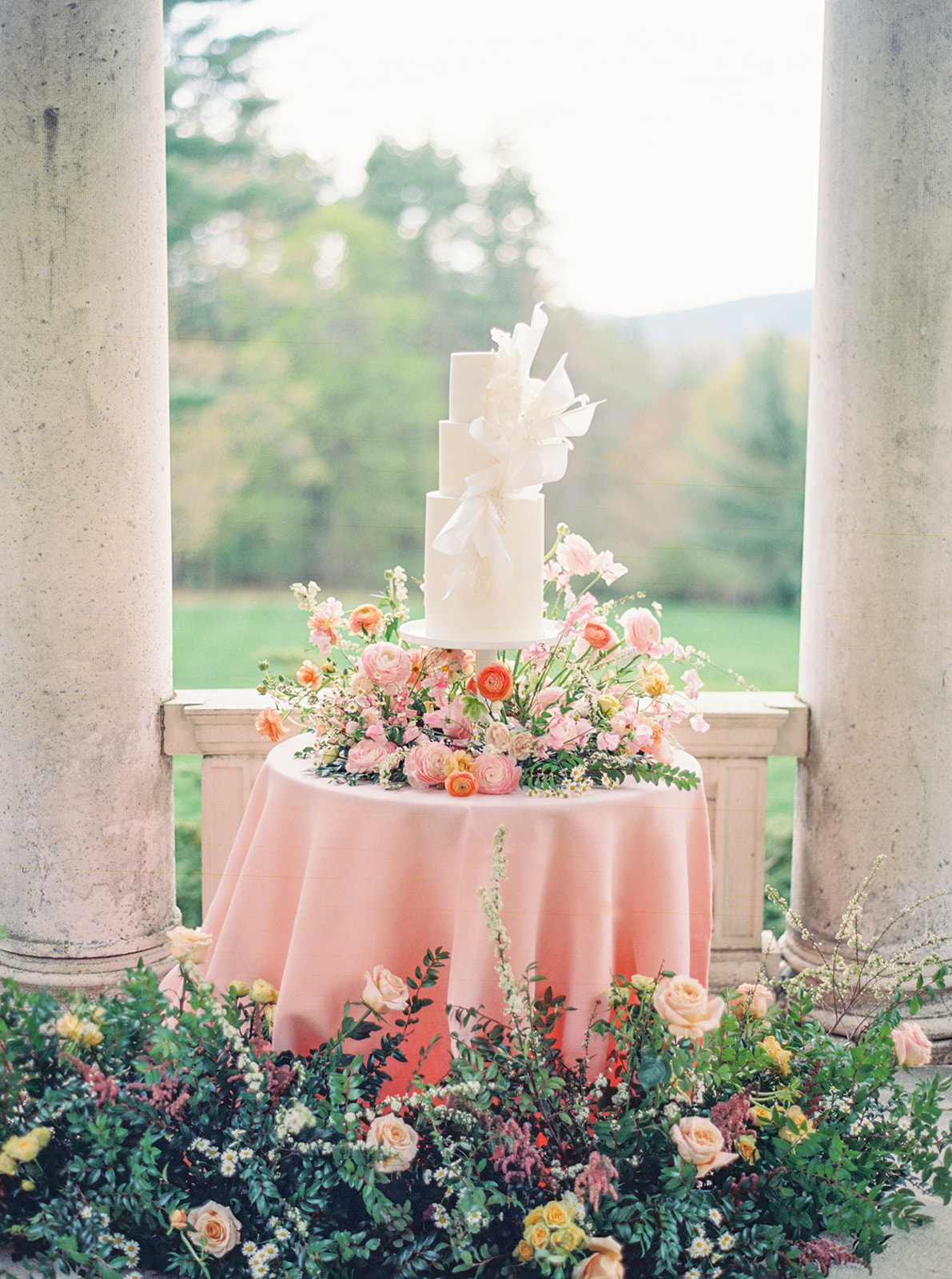 Garden party themed wedding cake table with pastel flowers