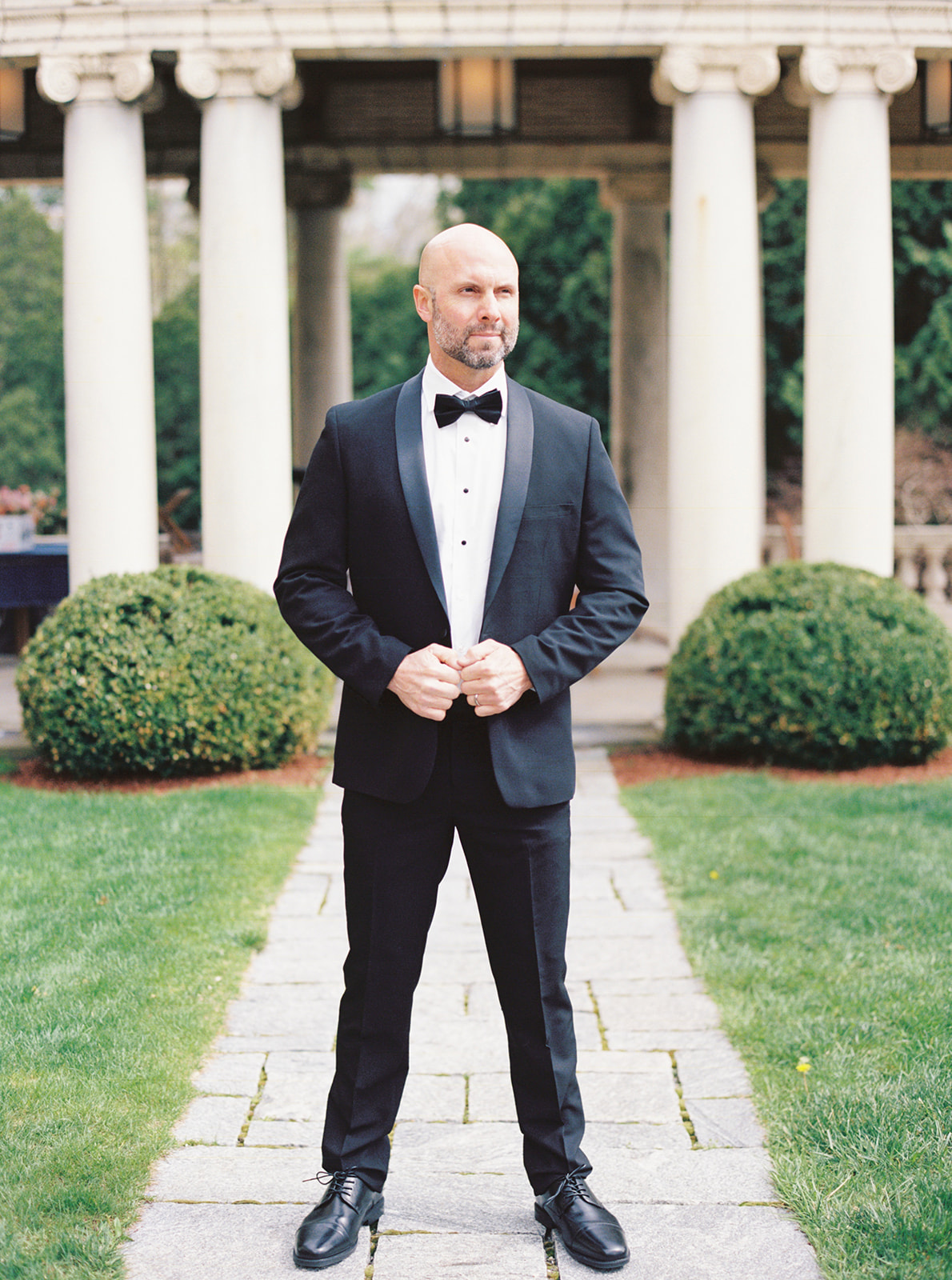Classic groom in timeless black wedding tuxedo and bowtie