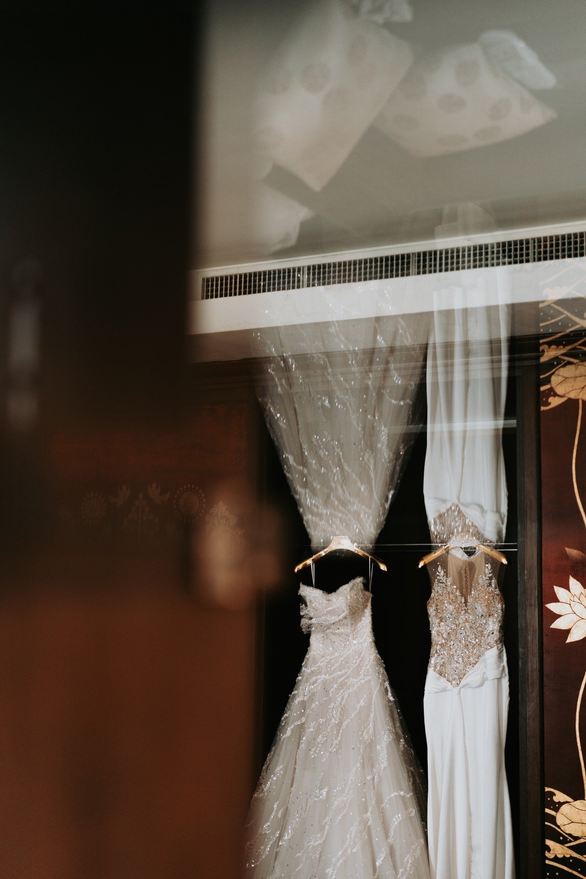 two wedding dresses hanging for getting ready photos