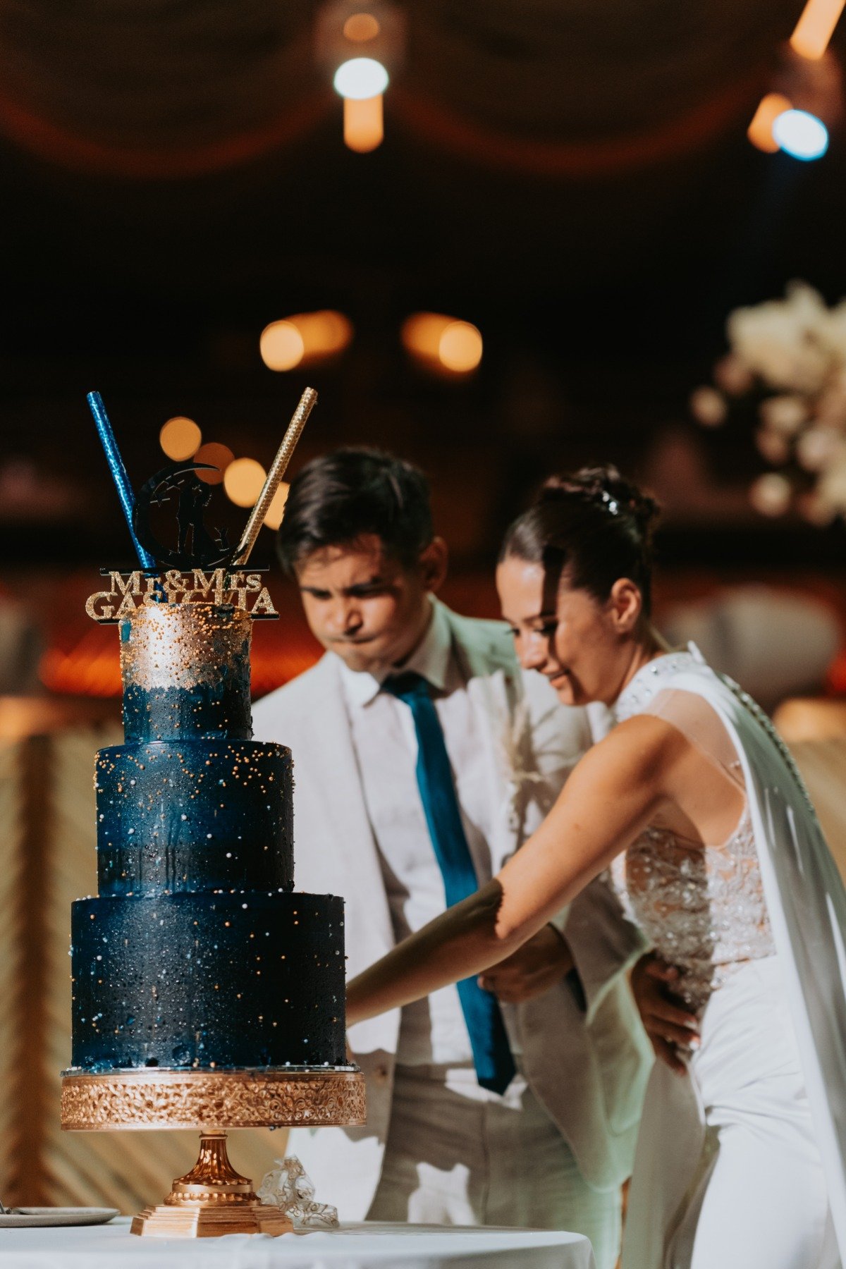 bride and groom cut night sky inspired wedding cake