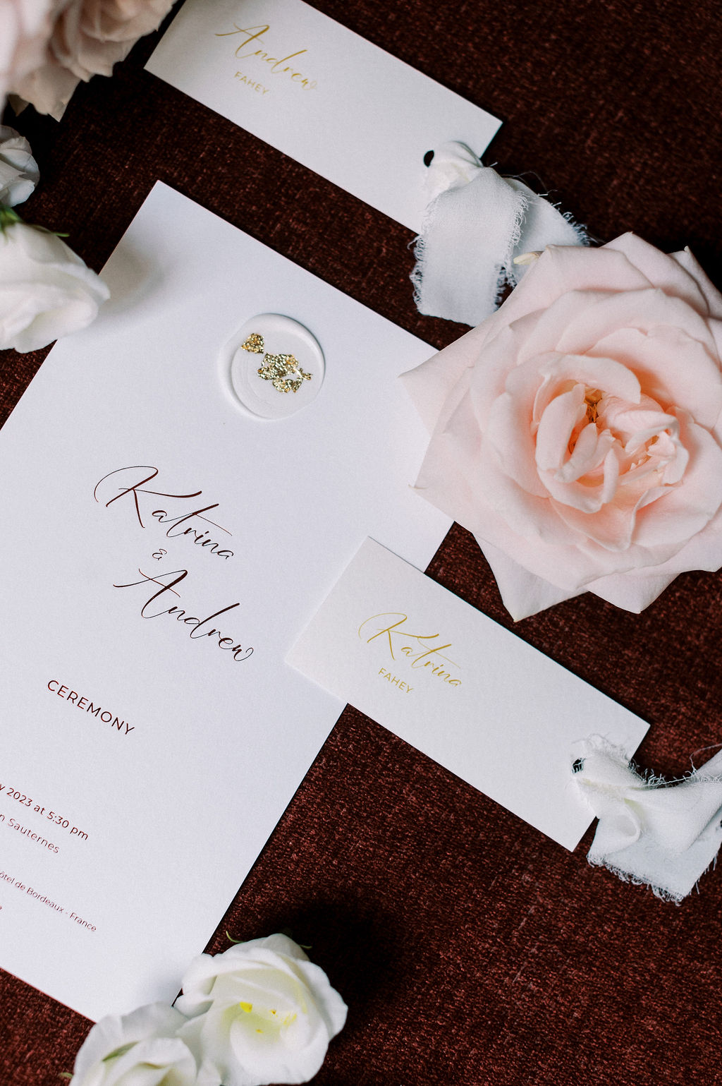 Elegant gold and white wedding invitations with name cards