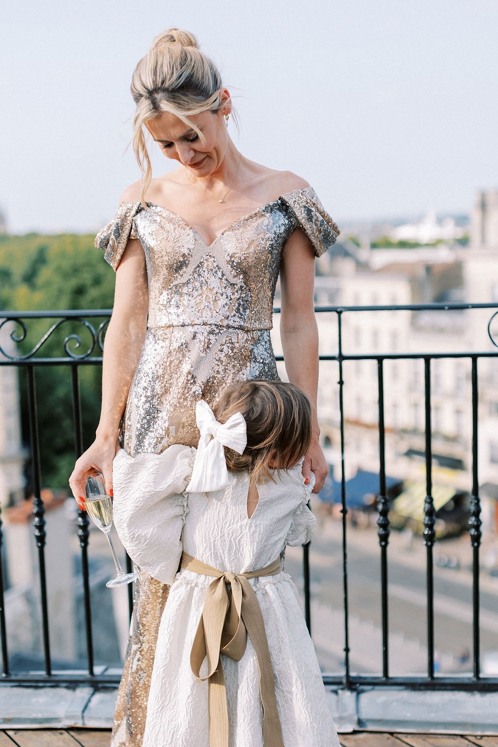 Chic daughter of the bride outfit in white and tan 
