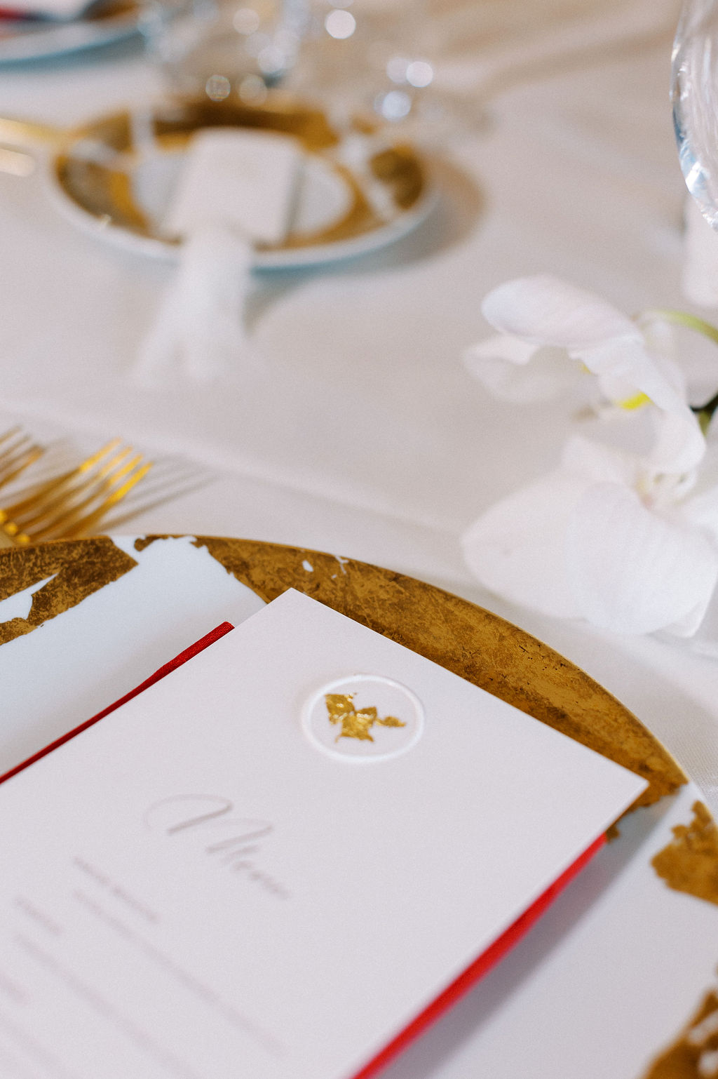 Elegant gold leaf dinner menu at romantic French dinner reception