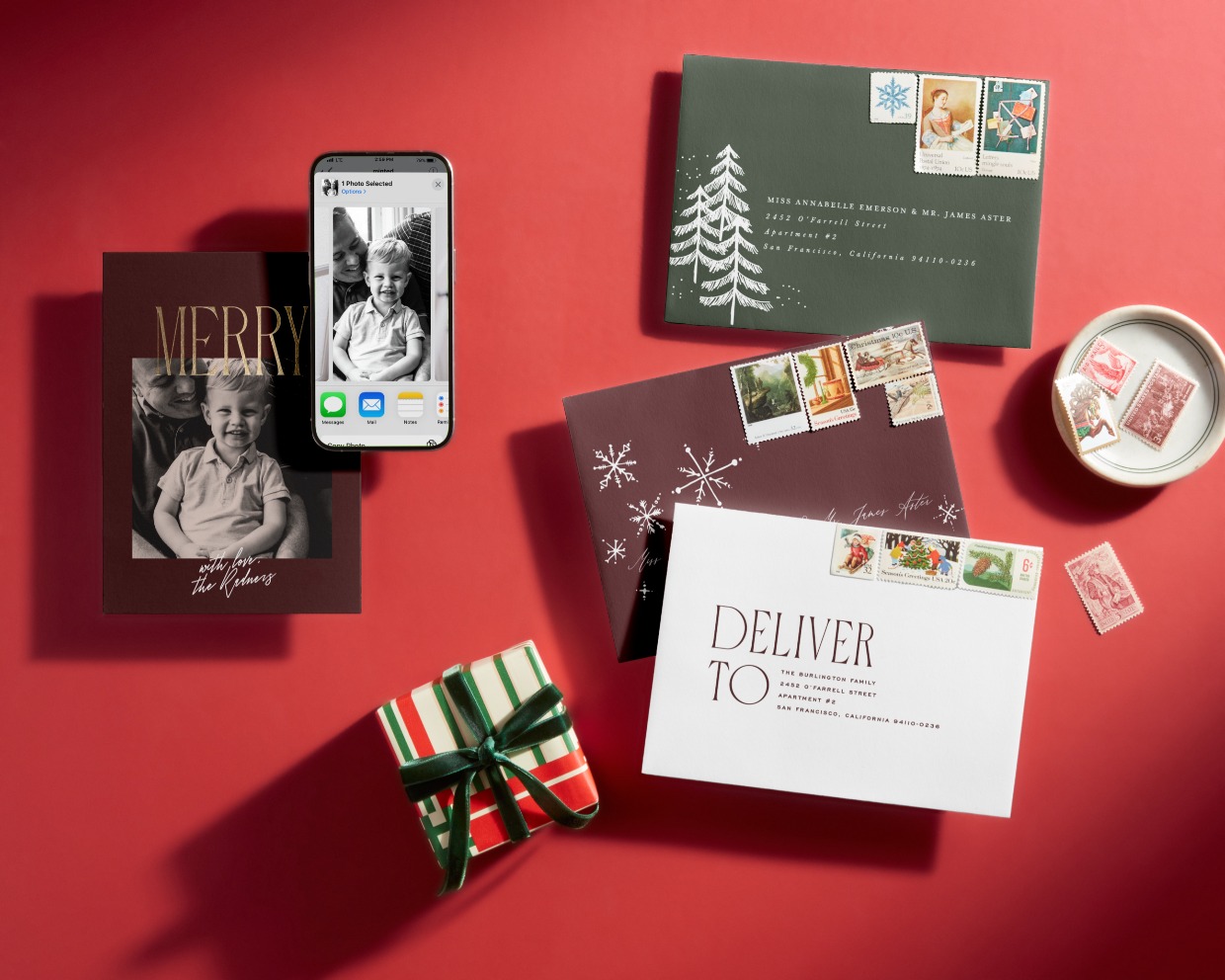 FY24_HOL24_Flatlay_Back_Cover_Envelope_HERO_With_Phone_H_0626_5736
