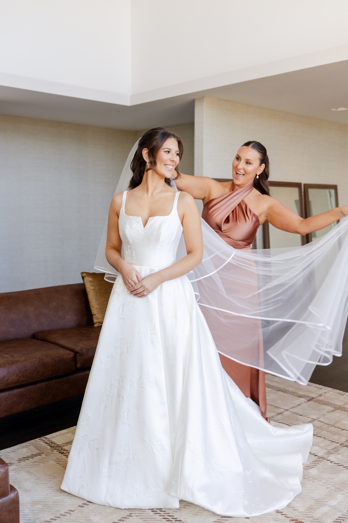 bridesmaid helping bride with veil