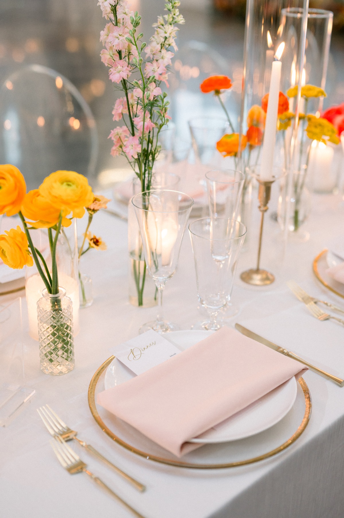 colorful flowers in bud vases for wedding centerpieces