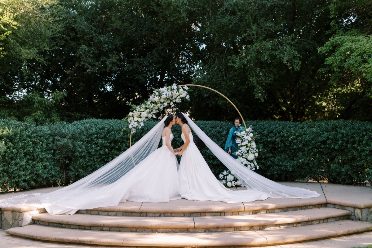 asymmetrical floral arch with white roses and greenery