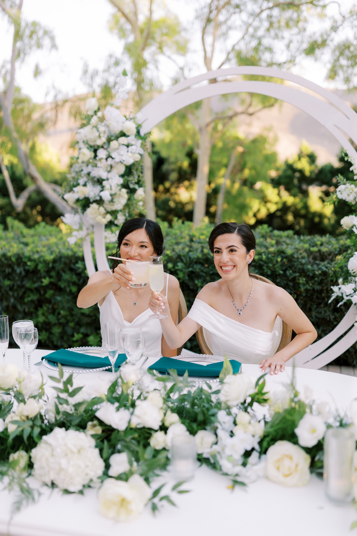 white roses and greenery centerpieces