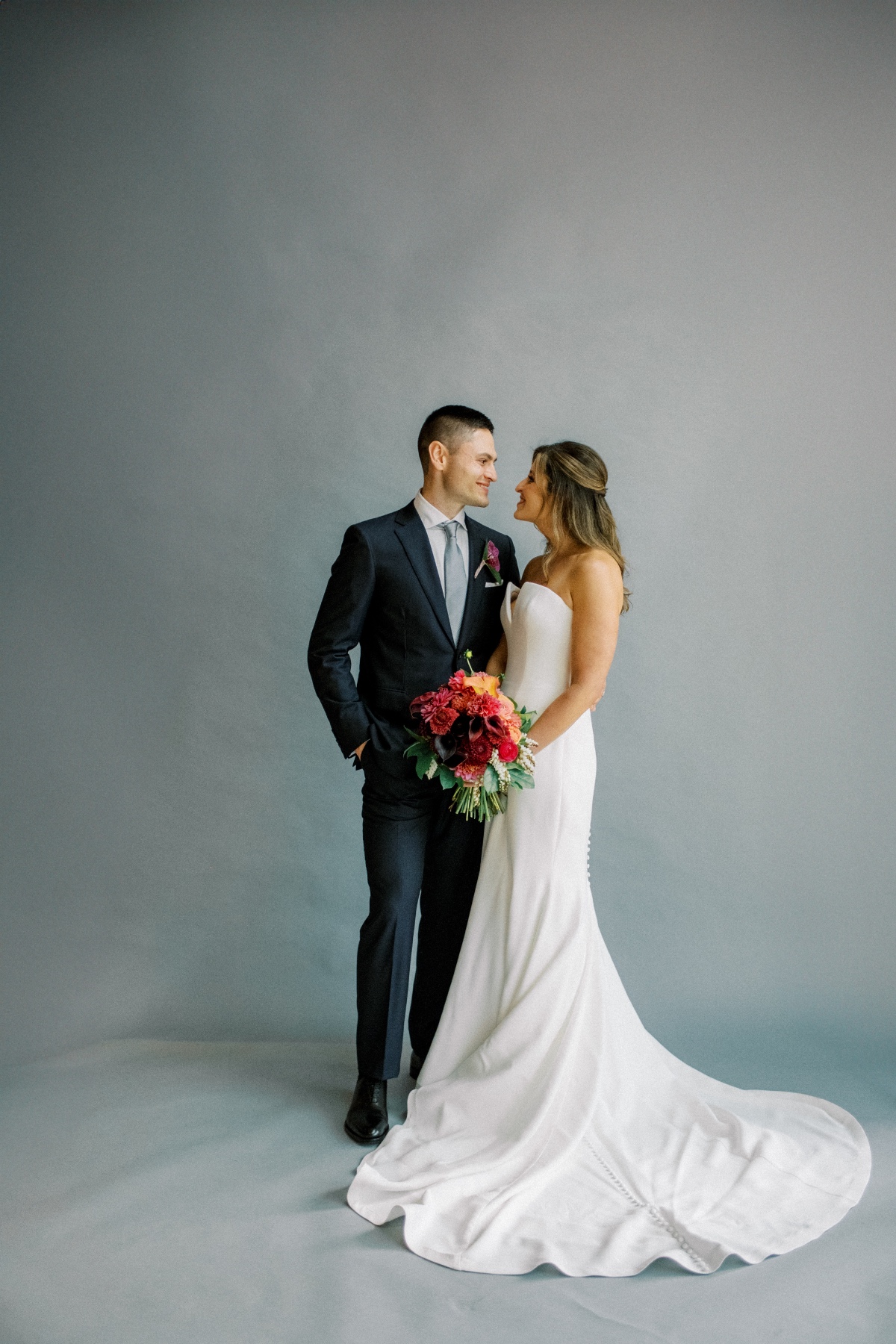 wedding portraits against a plain backdrop