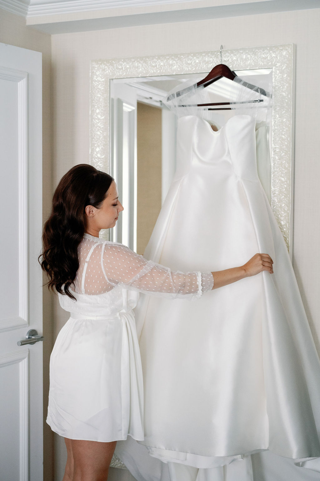 bride looking at her wedding gown photo ideas