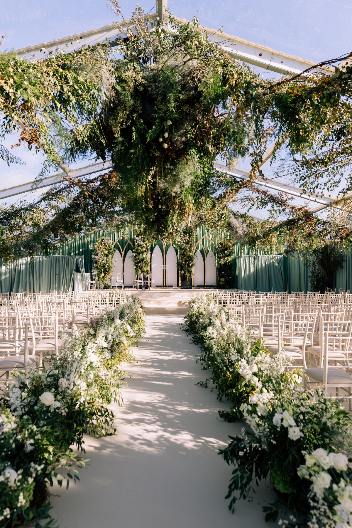 hanging greenery for tented wedding ceremony
