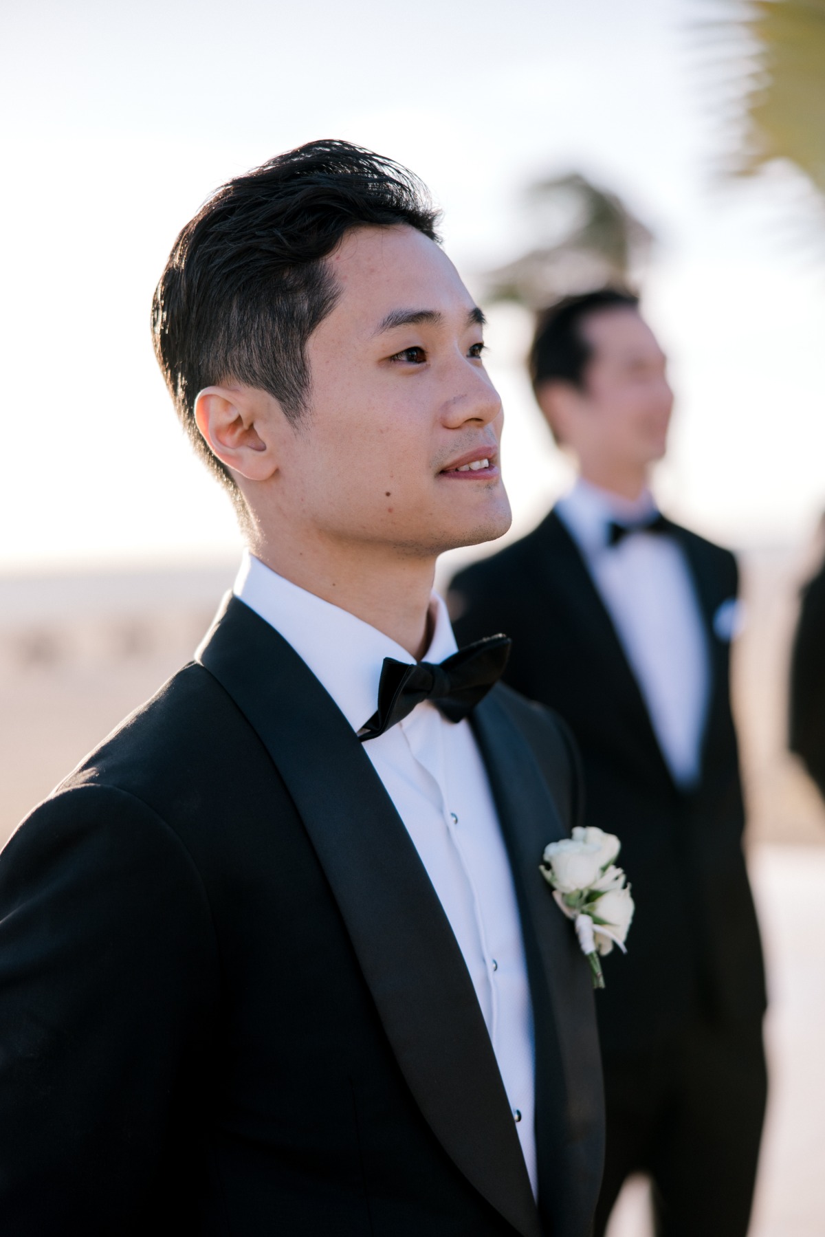 groom in tux at beach wedding