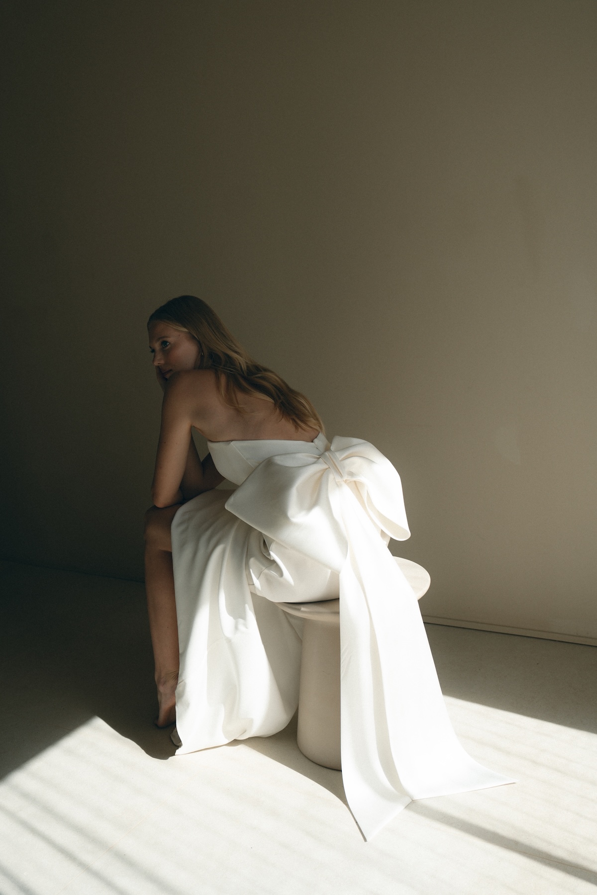 editorial style photo of bride in wedding dress with big back bow