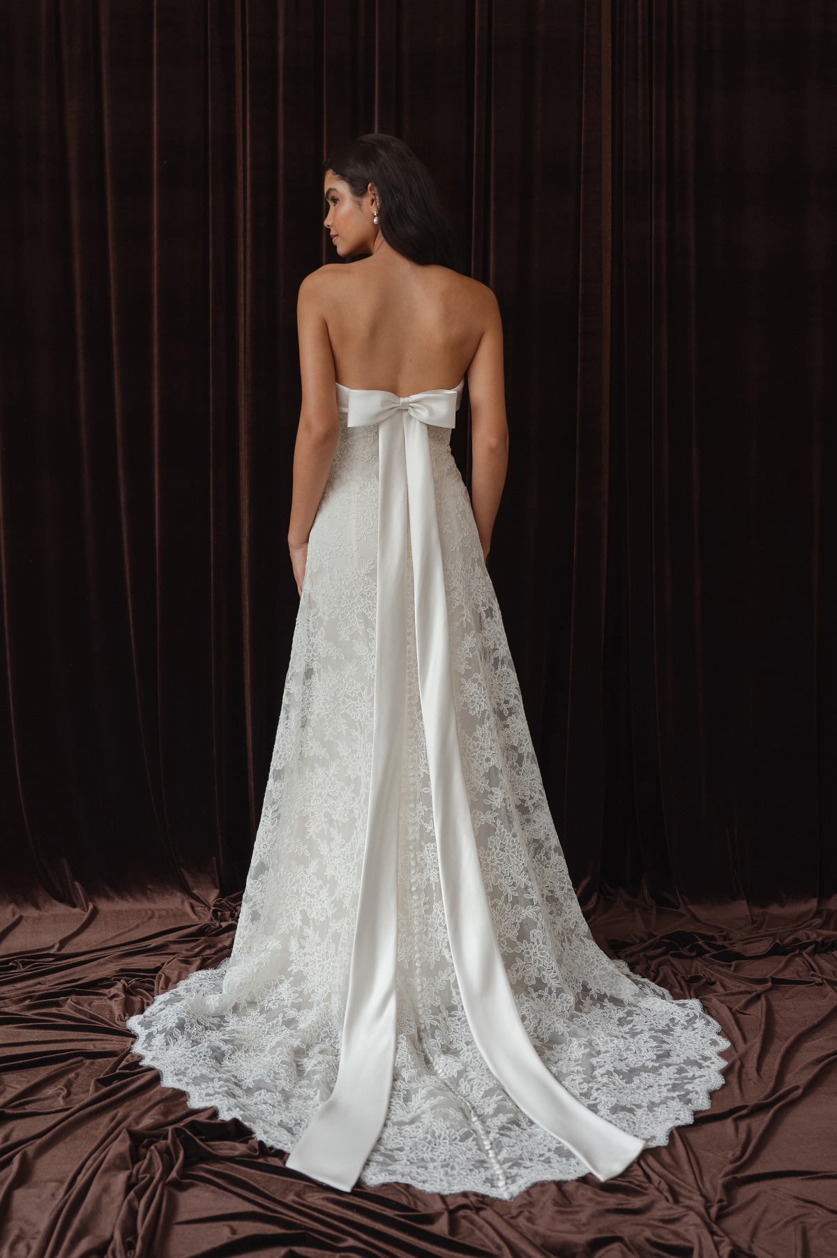 back of bride in wedding dress with bow