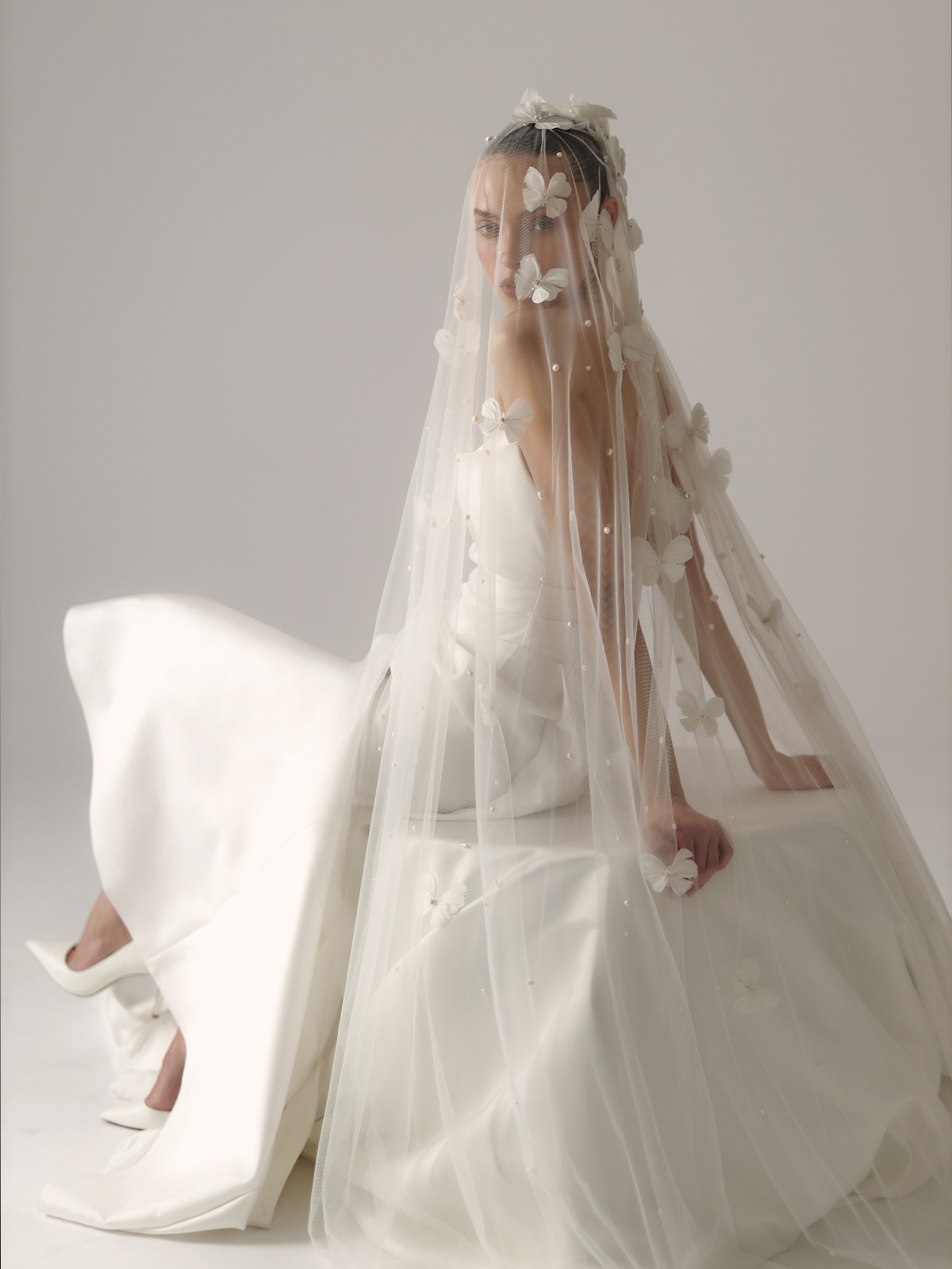 bride wearing butterfly veil and wedding dress