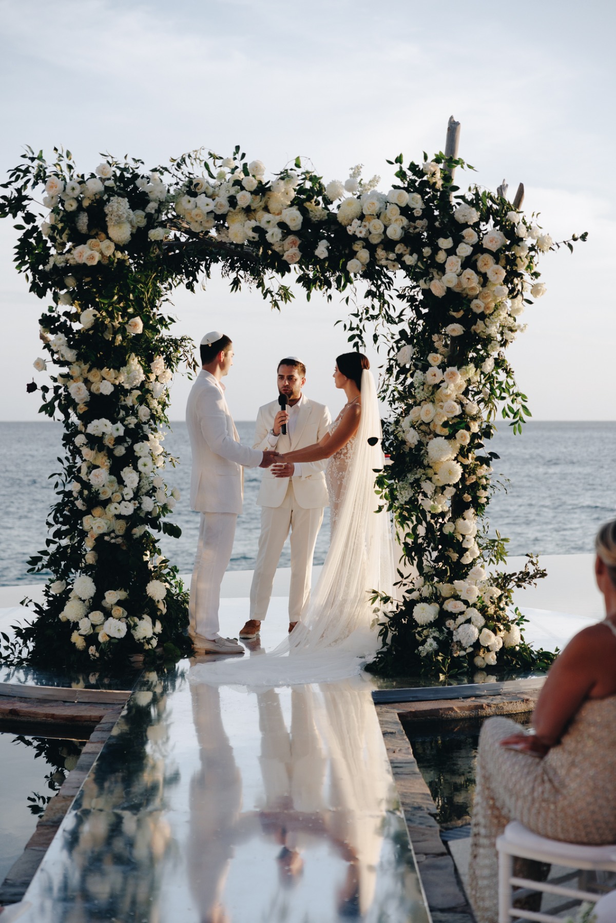 white rose and greenery floral arch