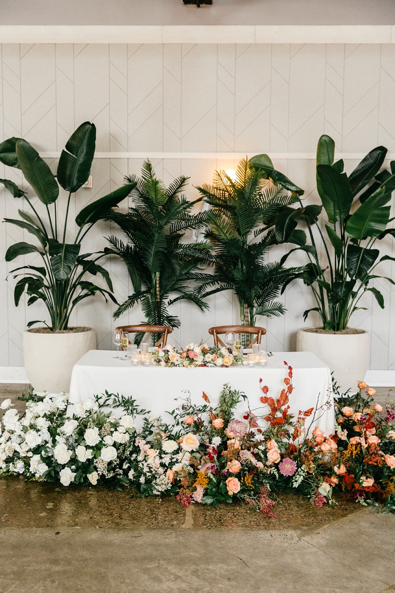 ombre floor level wedding floral arrangements and rented plants