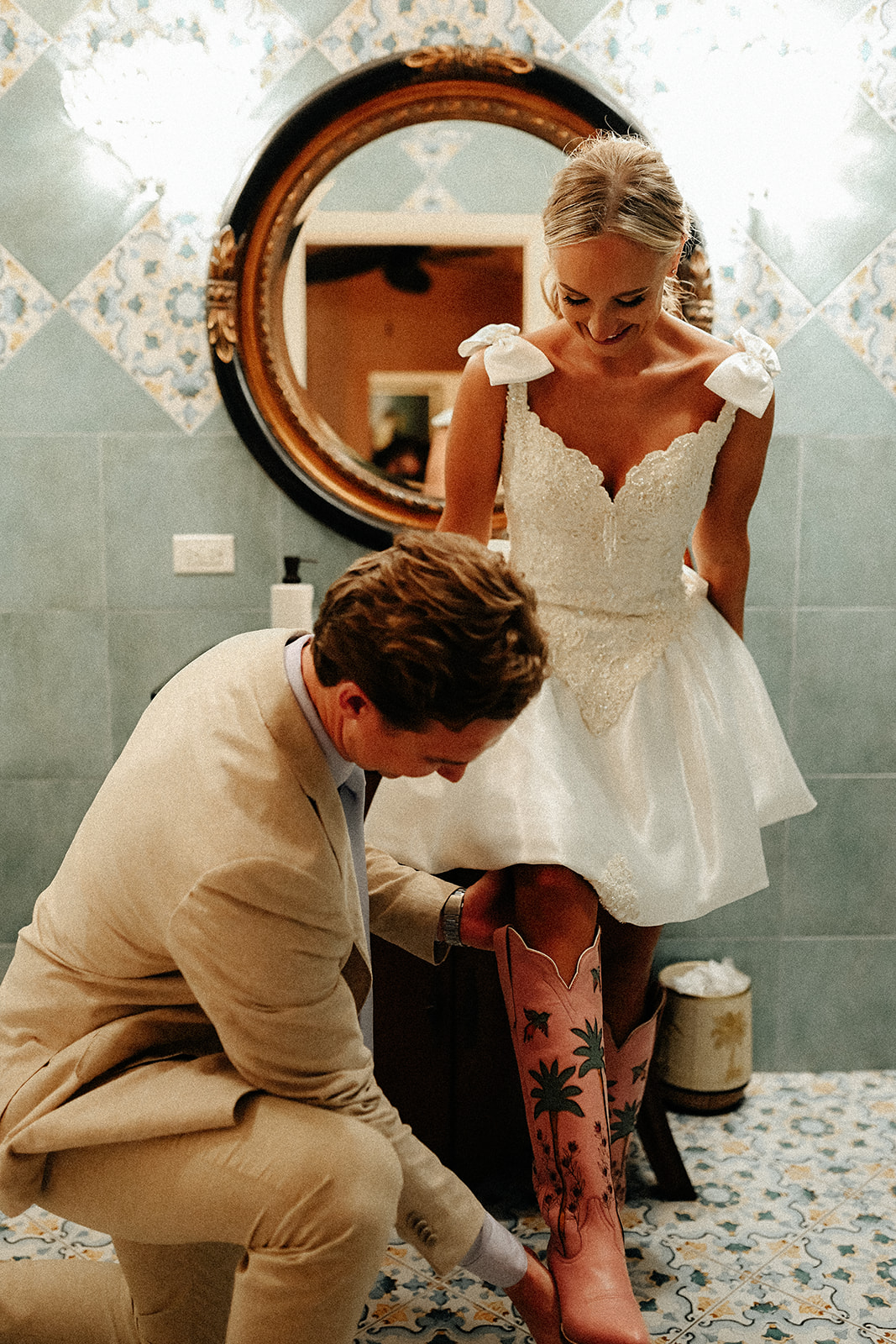 groom putting shoe on bride
